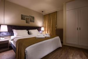 Postel nebo postele na pokoji v ubytování Kentrikon Hotel