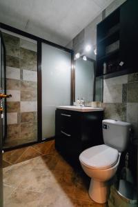 a bathroom with a toilet and a sink at Apartament Horatio in Galaţi
