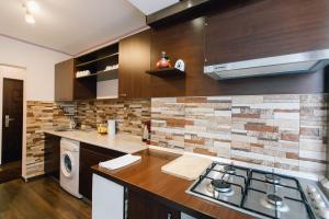 a kitchen with a sink and a stove in it at Apartament Horatio in Galaţi