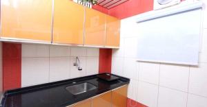 a small kitchen with a sink and a counter top at Hayat Jazan Furnished Units in Jazan