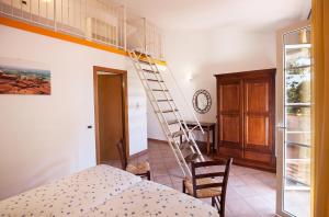 a bedroom with a ladder in a room with a bed at Massa Vecchia in Massa Marittima