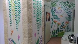 a bathroom with floral wallpaper on the walls at Albergo Diffuso Culturart House in Agrigento +37 photos