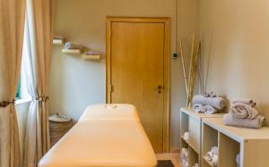 a room with a bed and a wooden door at Mirachoro Carvoeiro in Carvoeiro