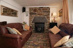 a living room filled with furniture and a fire place at Ivy House B&B in Dolgellau