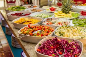 a buffet with many bowls of different types of food at Mirachoro Carvoeiro in Carvoeiro
