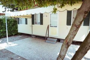 a building with awning and stairs in front of it at Camping Wien in Peschiera del Garda