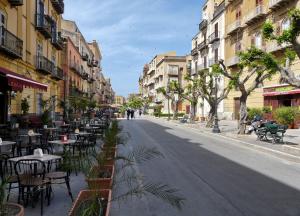 an empty street with tables and chairs and buildings at Cavaliere Costa in Porto Empedocle