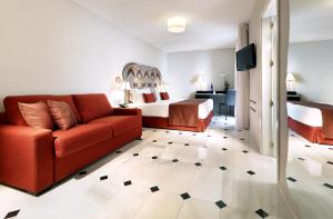 a living room with a couch and a bed at Eurostars Conquistador in Córdoba +71 photos