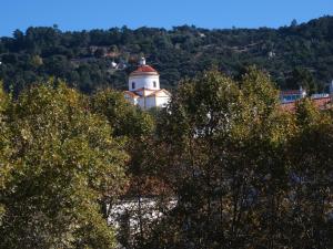 a lighthouse on top of a hill with trees at Alojamentos Casa Facha Papaia in Portalegre