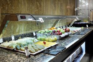 
a counter topped with lots of different types of food at Eurostars Conquistador in Córdoba
