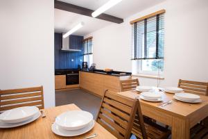 a kitchen and dining room with a wooden table and chairs at Nielestno 34 in Nielestno