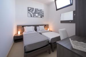 A bed or beds in a room at Villa Lupia
