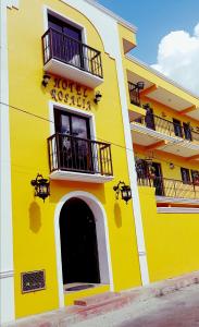 a yellow building with two balconies and a hotel at Hotel Rosalia in Valladolid