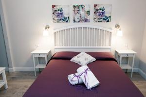 a bedroom with a bed with two tables and two towels at Soggiorno Arcobaleno in Florence