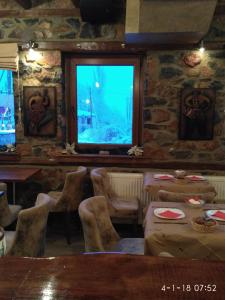 a restaurant with tables and chairs and a window at Rachati Kaimaktsalan in Palaios Agios Athanasios