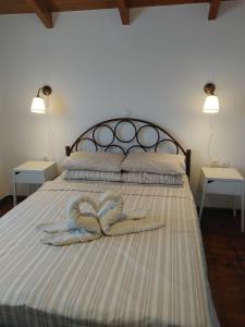 a bed with two towels in the shape of a heart at Villa Julia in Tsilivi
