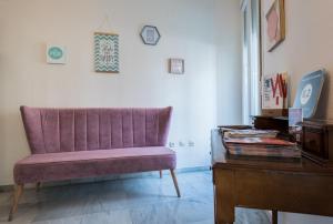 a living room filled with furniture and a painting on the wall at Jardin de la Alameda Hostal Boutique in Seville