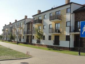 a row of apartment buildings on a street at Apartament Posejdon in Sztutowo