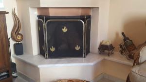 a fireplace with gold flames painted on the wall at Irini's home in Volos