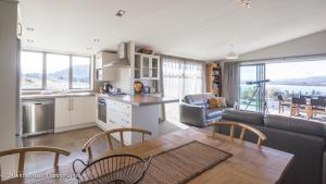 a kitchen and living room with a table and a couch at Hillcrest Lodge B - Lake Tekapo in Lake Tekapo