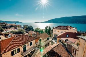a view of a town with the water and buildings at Apartments Master 5 in Herceg-Novi