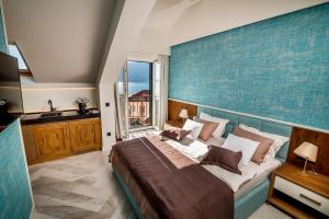 a bedroom with a large bed with a blue wall at Apartments Master 5 in Herceg-Novi