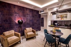 a living room with a table and chairs and a kitchen at Apartments Master 5 in Herceg-Novi