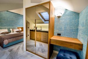 a bedroom with a bed and a sink and a mirror at Apartments Master 5 in Herceg-Novi