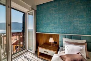 a bedroom with a bed and a large window at Apartments Master 5 in Herceg-Novi
