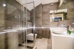 a bathroom with a shower and a toilet and a sink at Apartments Master 5 in Herceg-Novi