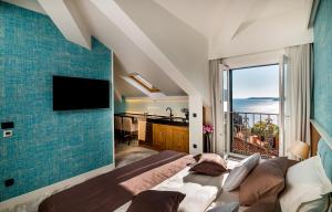 a bedroom with a bed and a view of the ocean at Apartments Master 5 in Herceg-Novi