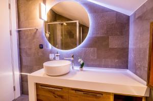 a bathroom with a sink and a mirror at Apartments Master 5 in Herceg-Novi