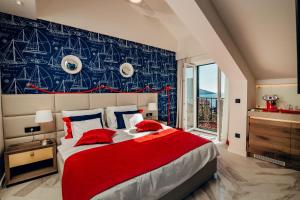 a bedroom with a large bed with a red blanket at Apartments Master 5 in Herceg-Novi