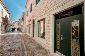 an empty street with people walking down the street at Apartments Master 5 in Herceg-Novi