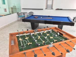 a ping pong table in a room with a football field at Residencia Jacarandas in Cuernavaca