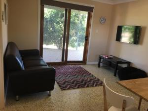 a living room filled with furniture and a window at Swan Valley Sisters in Henley Brook