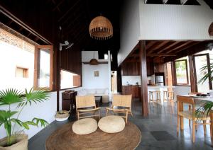 a room with two tables and chairs and a kitchen at Asmara Villa in Nusa Lembongan
