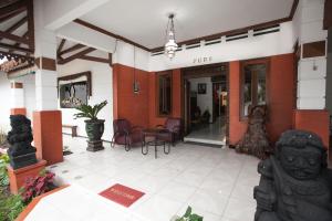 a lobby of a building with a statue in the foreground at RedDoorz near Brawijaya University in Malang