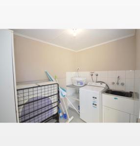 a small kitchen with a sink and a dishwasher at Claire’s Place in Kalbarri
