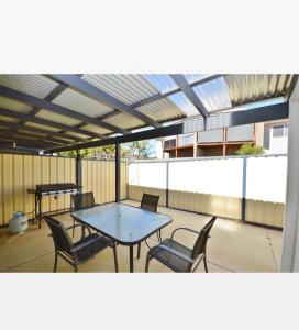 a patio with a table and chairs on a balcony at Claire’s Place in Kalbarri