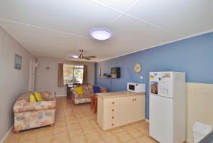 a kitchen and living room with a white refrigerator at Claire’s Place in Kalbarri