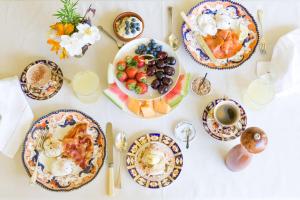a table with plates of food and a cup of coffee at The Corinda Collection in Hobart