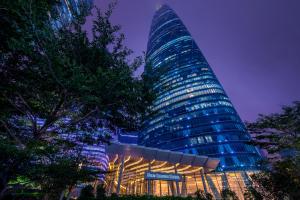 a tall building with a sign in front of it at Four Seasons Hotel Guangzhou in Guangzhou +76 photos