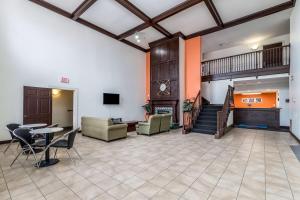 a large room with a lobby with a table and chairs at Motel 6-North Richland Hills, TX - NE Fort Worth in North Richland Hills