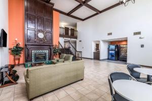 a living room with a couch and a fireplace at Motel 6-North Richland Hills, TX - NE Fort Worth in North Richland Hills