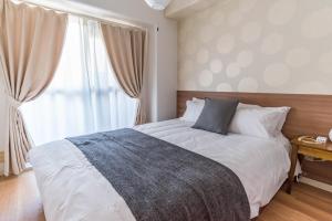מיטה או מיטות בחדר ב-Bijou Suites Kokoro