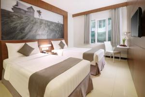 Postel nebo postele na pokoji v ubytování Hotel Neo Palma Palangkaraya by ASTON + 22 fotografií