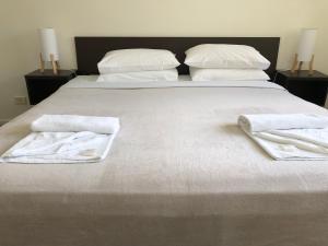 a hotel room with two beds and two night stands at Splendido Resort Apartments in Gold Coast