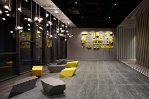 a room with yellow chairs and a wall with equipment at L7 Myeongdong by LOTTE in Seoul