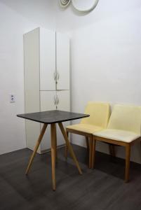 1 mesa y 2 sillas en una habitación en JK House, en Seúl